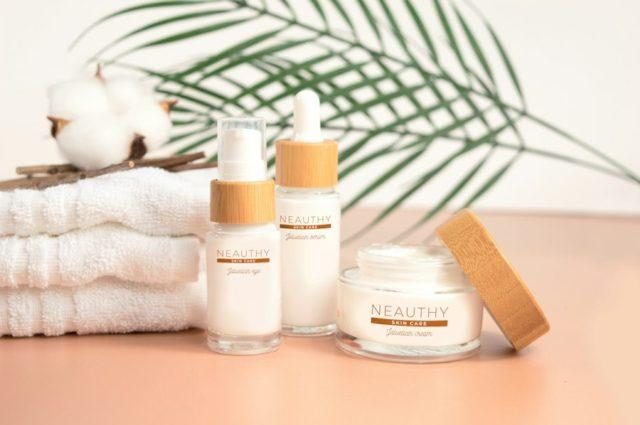 Skincare bottles on white textile