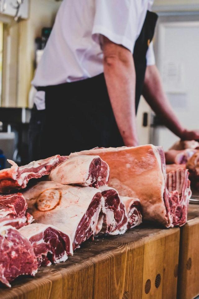 Butcher preparing cuts of meat